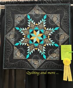 Teal, gold and black Feathered LeMoyne Star quilt with gold Honorable Mention ribbon.