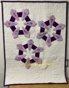 Lavender/purple Dresden plate quilt on white background