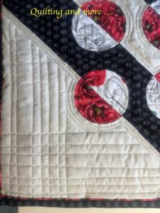 Detail of the previous quilt showing the straight-line quilting in the large outer off-white triangles.