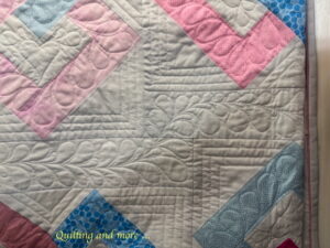 Detail of quilting, showing feathers in a meandering inner border.