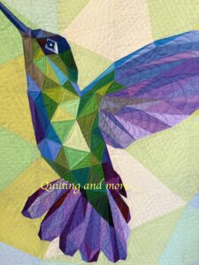 Detail of quilting on hummingbirds body and wing.
